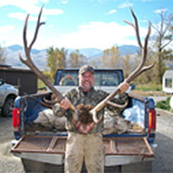 Hunter Holding Large Elk Antlers